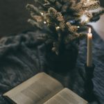 white book page with lighted candle