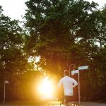 man in running on pathway near trees