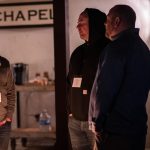 a group of men standing in a room