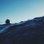 silhouette photography of person on body of water