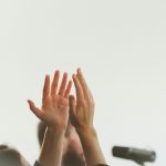 persons hand on white textile