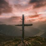 grey wooden cross on mountain