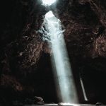 water falls on brown rocky mountain