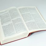 an open book sitting on top of a white table