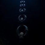 a long line of people in the dark