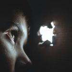 person watching through hole