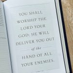 An open bible on a wooden table