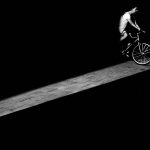 man riding bicycle in dark area