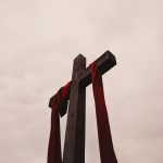 low angle view of cross with red garment