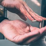 person wearing silver band ring