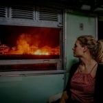 woman sitting along window