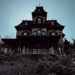 an old house with a steeple and a clock tower