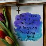 a watercolor painting of a bible and a flower