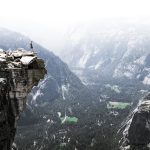 man on mountain cliff