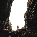 man standing on cave