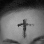 cross on person's forehead
