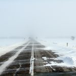 a snow covered road in the middle of nowhere