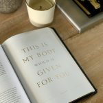 an open book sitting on top of a wooden table