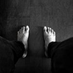 grayscale photography of person wearing pants
