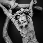 a statue of a person holding a stick