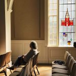 man in gray dress shirt sitting on chair