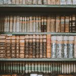 a bookshelf filled with lots of old books