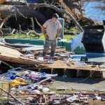 a man standing on top of a pile of junk